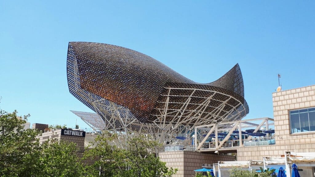 Working on your vacation is a workcation Image of the large metal fish on the beach in Barcelona - Photo Credit: Margarita Ibbott DownshiftingPRO