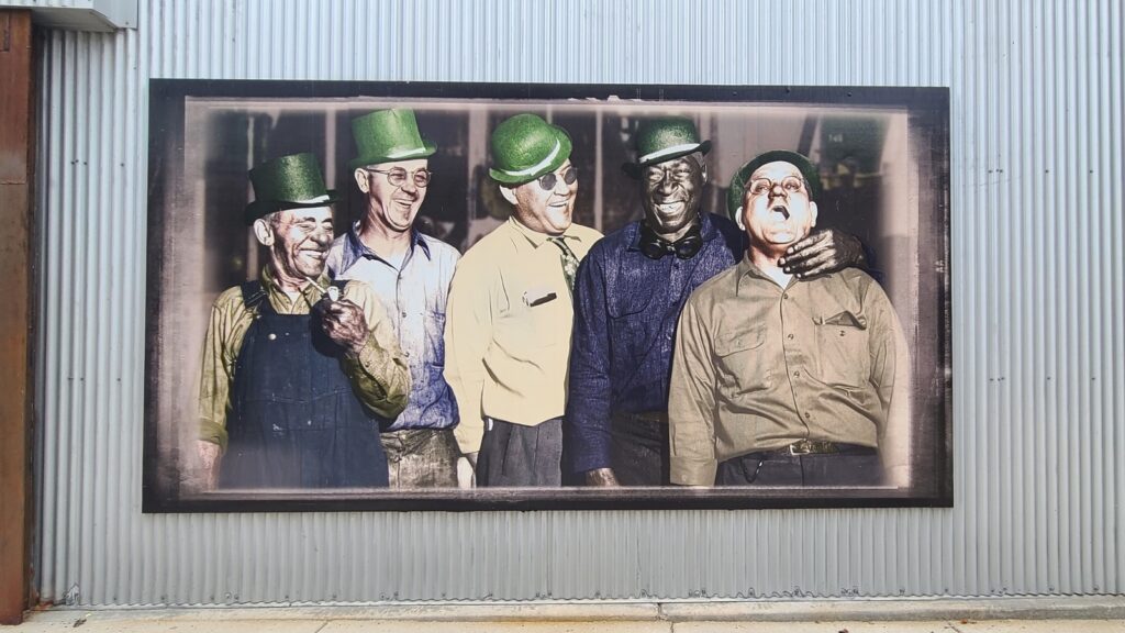 An old photograph of five Ironworkers joking around.  In Beloit, WI