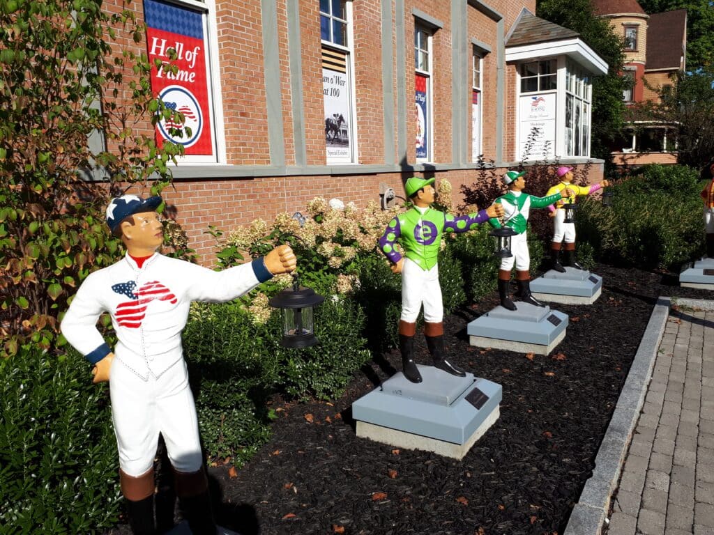 Great Art & Quirky Museums NOT in New York City 19 Lawn Jockeys in front of the National Museum of Racing and Hall of Fame in Saratoga Springs NY DownshiftingPRO